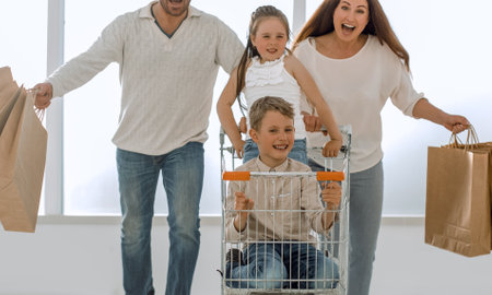 happy family with cart and kidsの写真素材