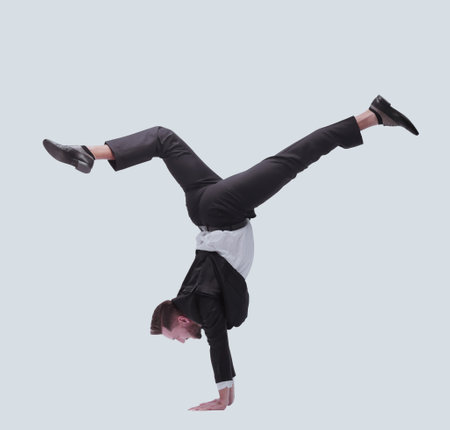 in full growth. happy young businessman dancing break dance