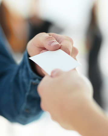 close up. young people exchanging their business cards