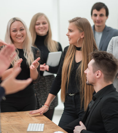 happy working group applauding in the workplace