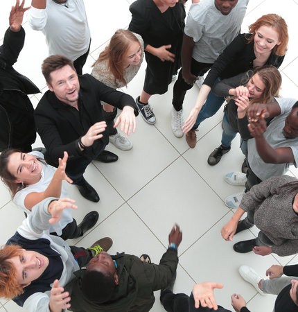 Multiethnic group of smiling young people celebrating success an