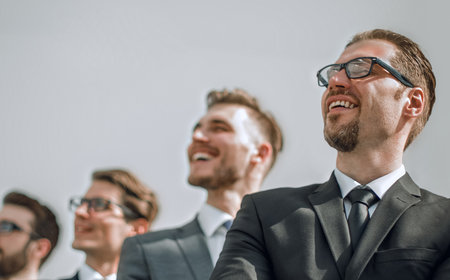 successful businessman standing in front of business teamの写真素材