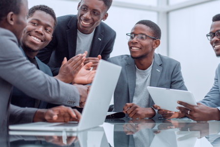 group of employees looking at the screen of a digital tablet.の写真素材