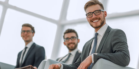 young successful businessman on background of office.の写真素材