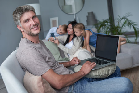 portrait of happy father, against the background of her happy familyの写真素材
