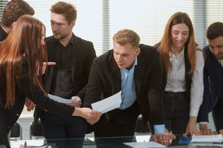group of employees enthusiastically discussing business documents .