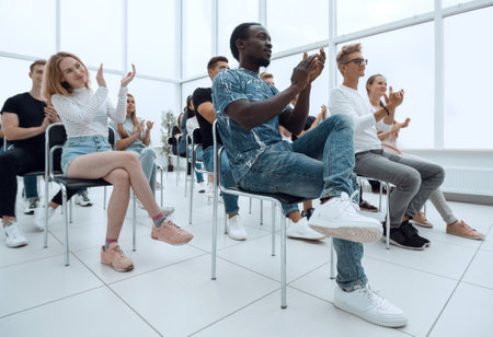 group of young people applauding at a business seminar