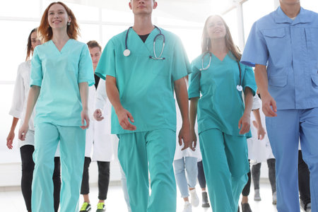 group of happy young medical professionals showing their successの写真素材