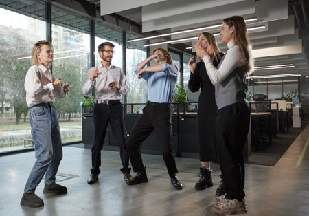A group of people are dancing in a room