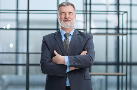 A man in a suit and tie is smiling and looking at the cameraの写真素材