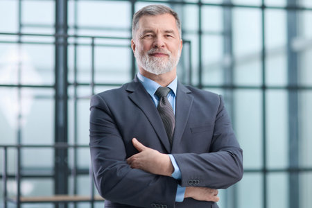 A man in a suit and tie is smiling and looking at the camera