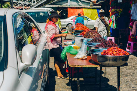 Yangon, Myanmar - FEB 19th 2014: Burmese female street food vendor in Bogyoke Aung San Marketのeditorial素材