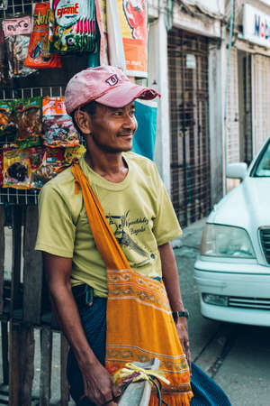 Yangon, Myanmar - FEB 19th 2014: Burmese male street fruit vendor on the streetのeditorial素材