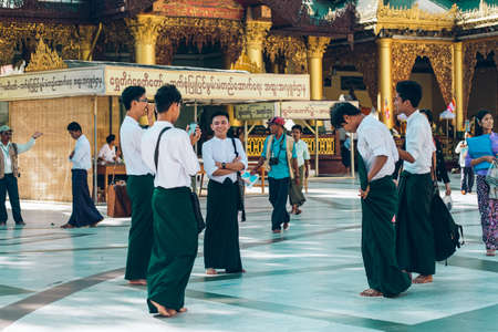 Yangon, Myanmar - FEB 19th 2014: People stand in front of temple at Shwedagon Pagodaのeditorial素材