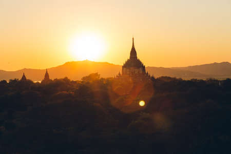 Bagan, Myanmar - FEB 21th 2014: Sunset landscape view with silhouettes of Buddhist monuments temple