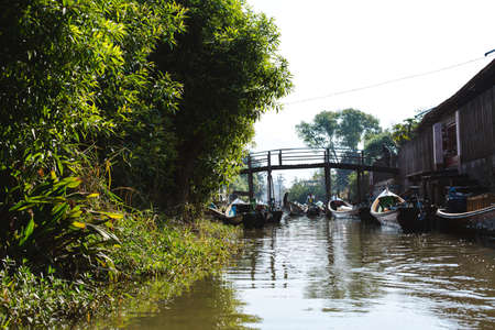 Inle Lake, Myanmar - FEB 25th 2014: Intha people working on tourist boat in Inle Lake, Myanmarのeditorial素材