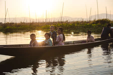 Inle Lake, Myanmar: FEB 25, 2014: Intha people, woman and child rowing boat on Inle Lakeのeditorial素材