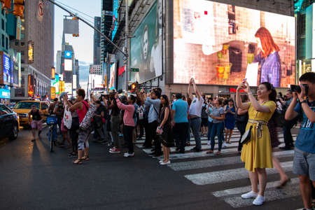 New York City / USA - JUL 13 2018: Manhttanhenge street view from Times Square at rush hour in...