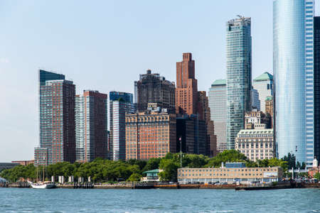 New York City / USA - JUL 14 2018: Lower Manhattan Skyline view from Governors Island ferry on a clear afternoonのeditorial素材