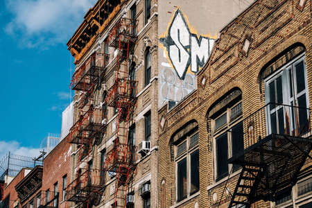 New York City - USA - Mar 19 2019: Typical brick buildings of Chinatown with sings in Lower Manhattanのeditorial素材