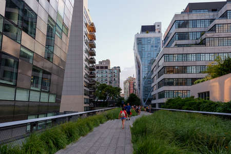 New York NY - USA - Jul 24 2019: The High Line Park in New York with locals and tourists. The High Line is a popular linear park built on the elevated train tracks above Tenth Ave in New York Cityのeditorial素材