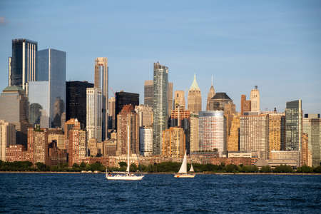 Jersey City, NJ - USA - Aug 30 2019: Lower Manhattan skyline with boat and ferry on Hudson river view from Liberty State Park in late summerのeditorial素材
