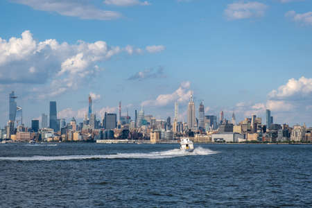 Jersey City, NJ - USA - Aug 30 2019: Lower Manhattan skyline with boat and ferry on Hudson river view from Liberty State Park in late summerのeditorial素材