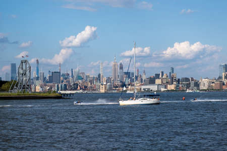 Jersey City, NJ - USA - Aug 30 2019: Lower Manhattan skyline with boat and ferry on Hudson river view from Liberty State Park in late summerのeditorial素材
