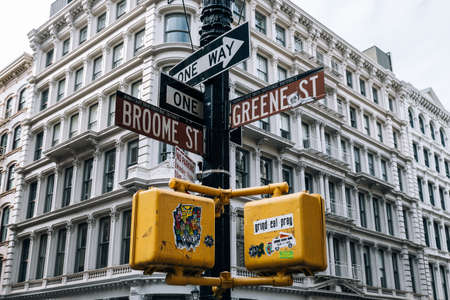 New York City - USA - Dec 6 2019: Street signs and traffic lights with stickers in SOHO New York Cityのeditorial素材