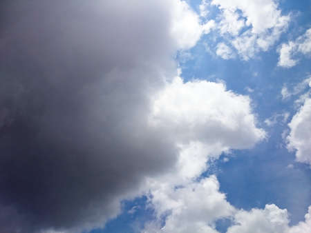 White and dark cloudy with blue sky