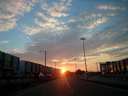View of morning sunrise from a road in housing area. Flare effectの写真素材