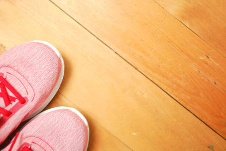 Flat lay of dumbbell, watch strap, heart rate belts, sport shoe, orange from top view. Sport equipments and fitness items concept.の写真素材
