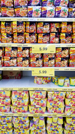 MELAKA, MALAYSIA - April 13, 2018 : Maggi on shelf rack display in the Tesco store. Maggi is a popular brand of instant mi producer in Malaysiaのeditorial素材