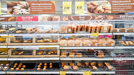 MELAKA, MALAYSIA - April 13, 2018 : Assorted type of cake, bread and bun on shelf rack display in...