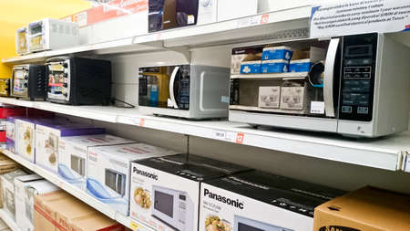 MELAKA, MALAYSIA - April 13, 2018 : Assorted brand and type of microwave on shelf rack display in the Tesco store.のeditorial素材