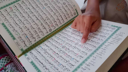 The kid of muslim reading a holy Quran during Ramadan monthの写真素材