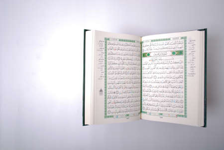 The holy Quran isolated over white background. Muslim holy book and guidanceの写真素材