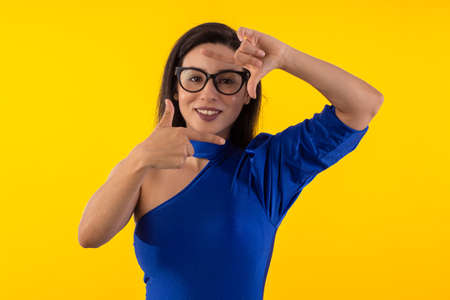 Studio shot of young woman in white shirt on yellow background with various facial expressions.