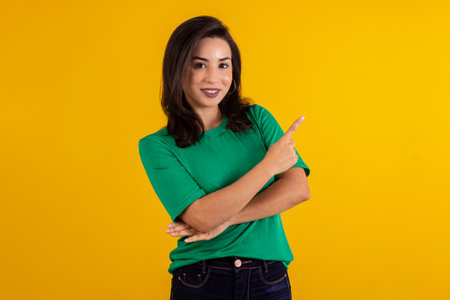 Studio shot of young woman in white shirt on yellow background with various facial expressions.の写真素材