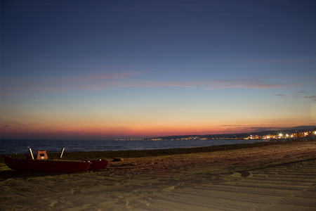 A night view of a baywatch boat on a beach 
の写真素材