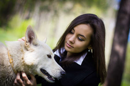cute girl with a dog in the forest