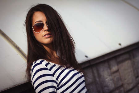 Portrait of stylish woman with glasses on the streetの写真素材