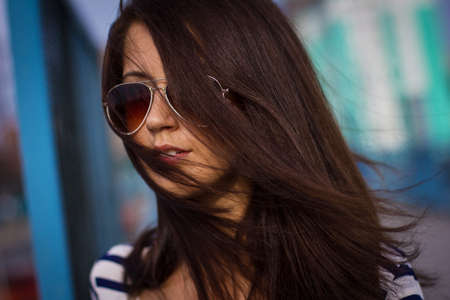 Portrait of stylish woman with glasses on the streetの写真素材