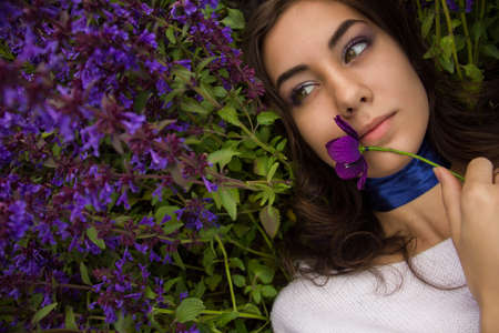 portrait of a girl lying on a flower meadowの写真素材
