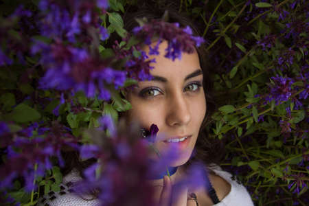 portrait of a girl lying on a flower meadowの写真素材