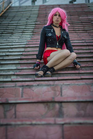 girl with a tattoo in a wig on the stairsの写真素材