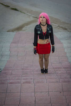 girl with a tattoo in a wig on the stairsの写真素材