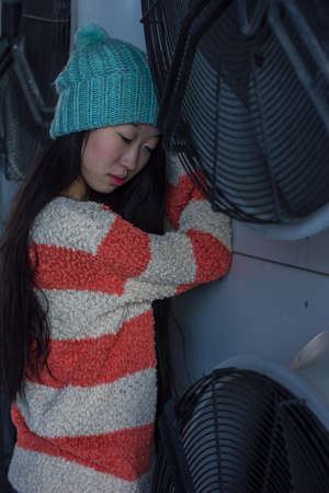 portrait of stylish Asian girls near air conditionersの写真素材