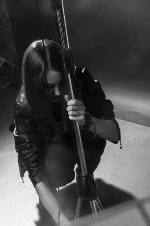 girl singing into a microphone in a studioの写真素材