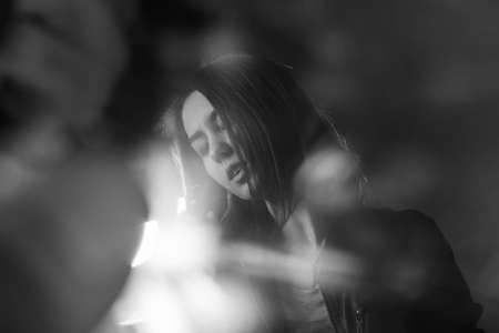 girl singing into a microphone in a studioの写真素材